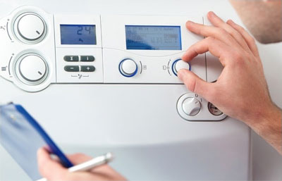 Person inspecting boiler