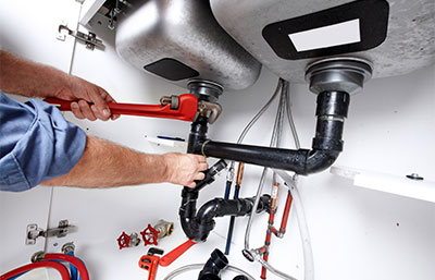 Man fixing sink plumbing